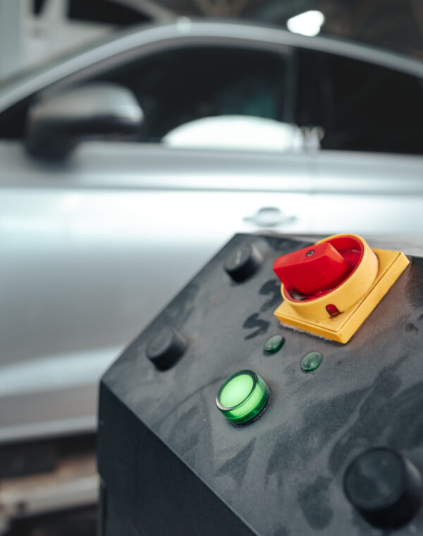 Control panel of a car lift hoist crane in auto service garage close up