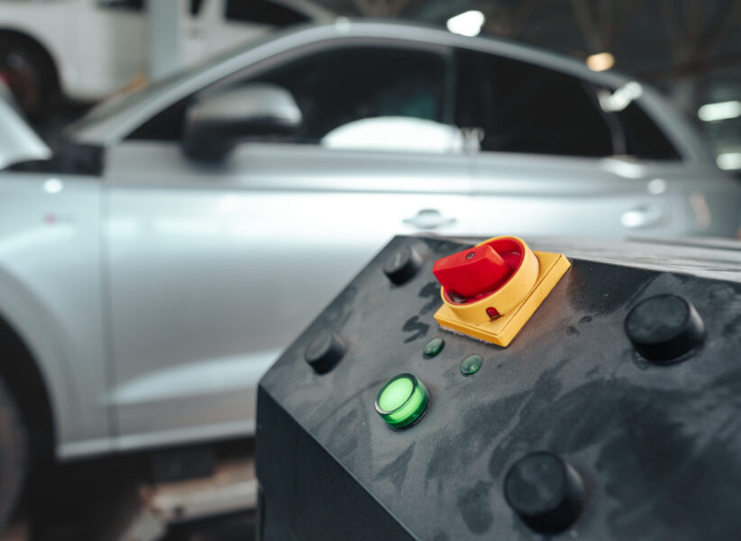 Control panel of a car lift hoist crane in auto service garage close up