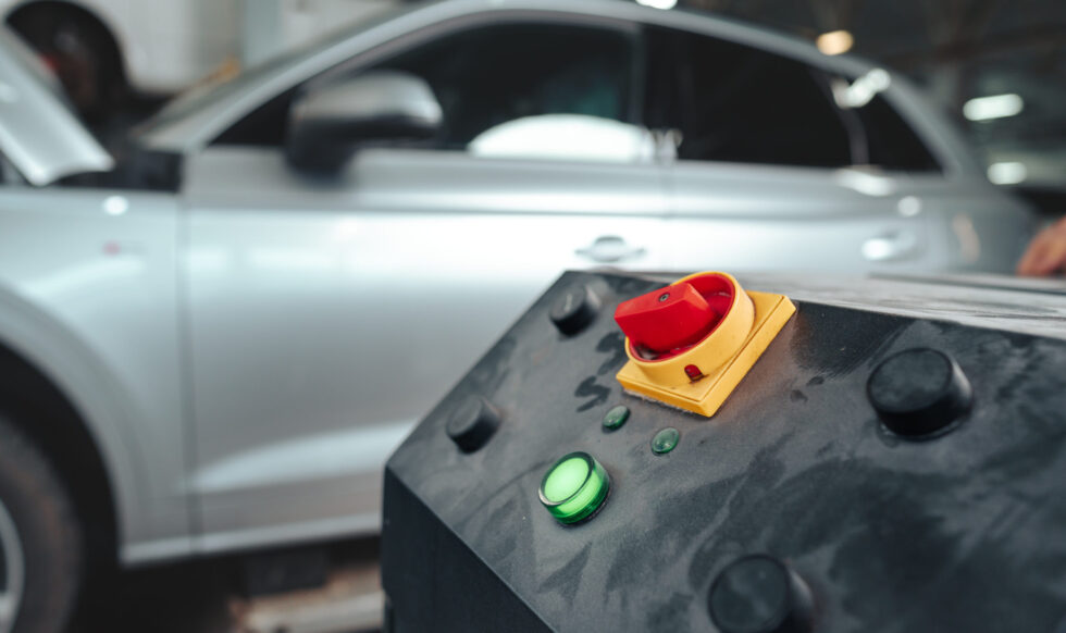 Control panel of a car lift hoist crane in auto service garage close up